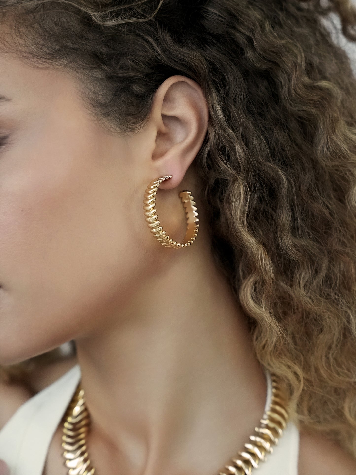 Large Metal Moderna Hoops on model 2