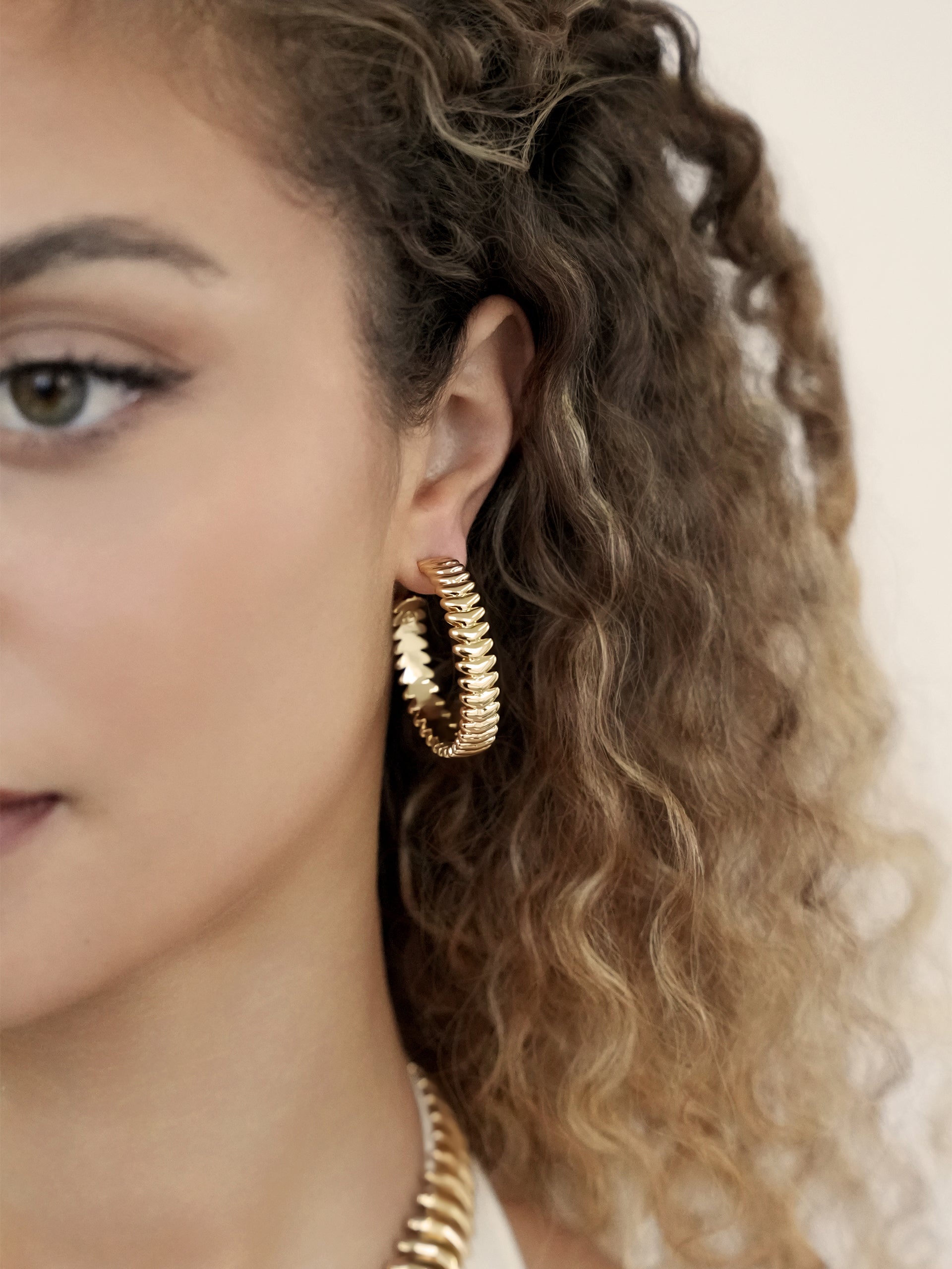 Large Metal Moderna Hoops on model