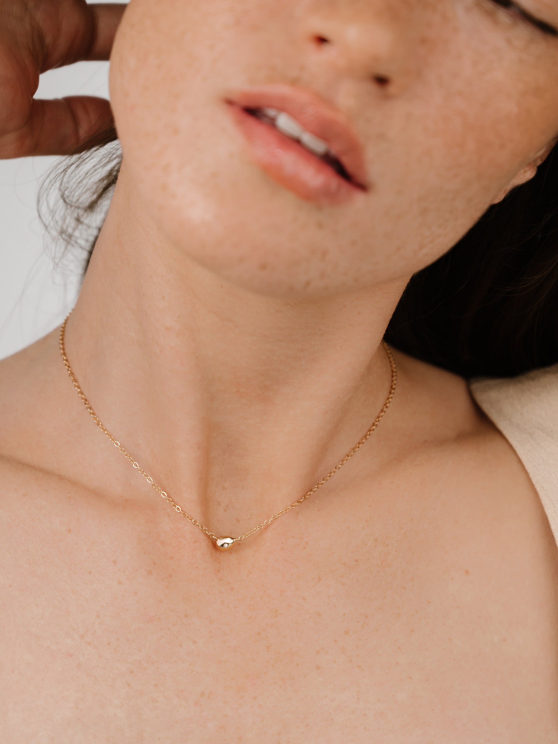 Polished Dainty Pebble Pendant Necklace on model 3