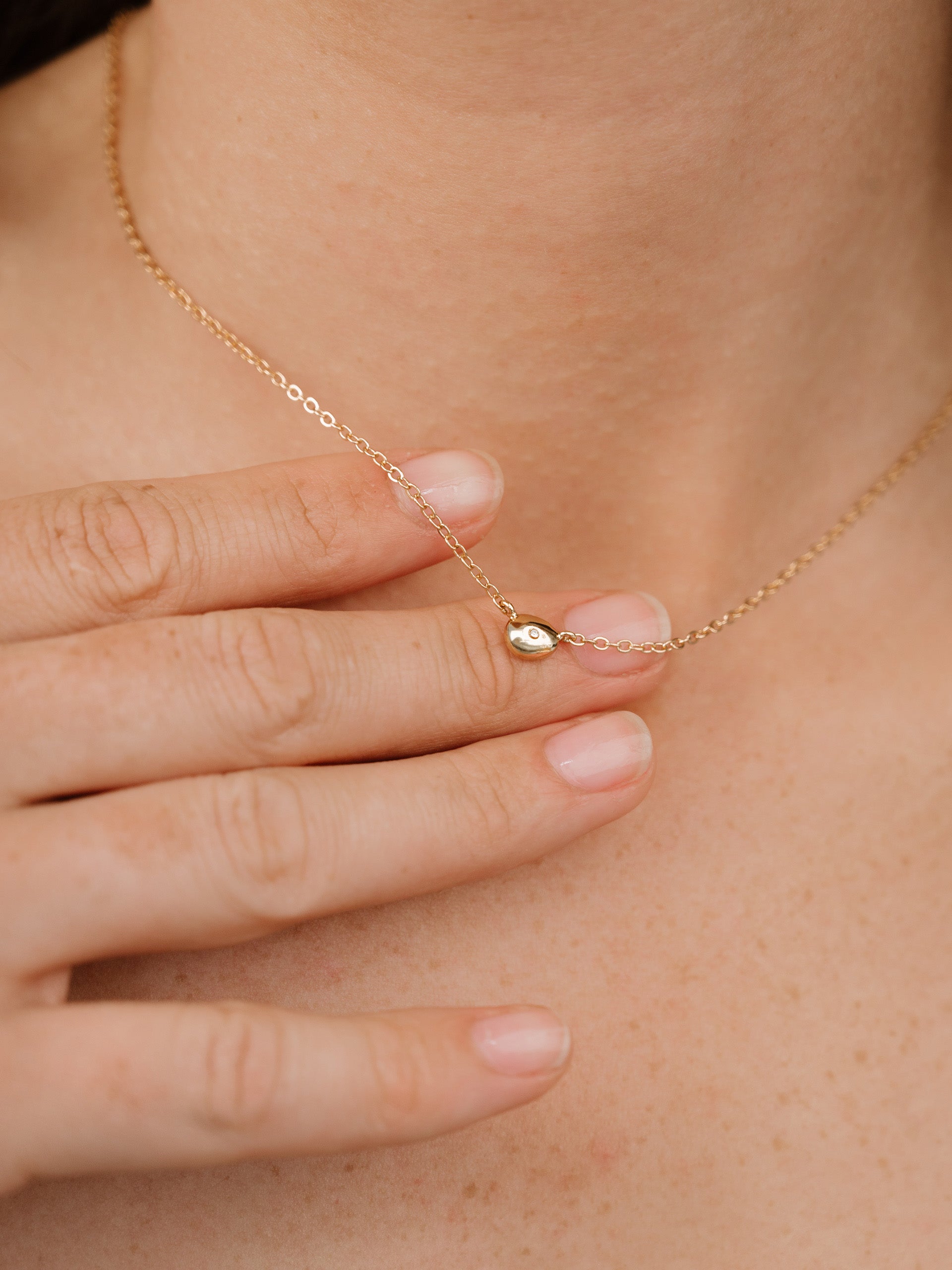 Polished Dainty Pebble Pendant Necklace on model 4