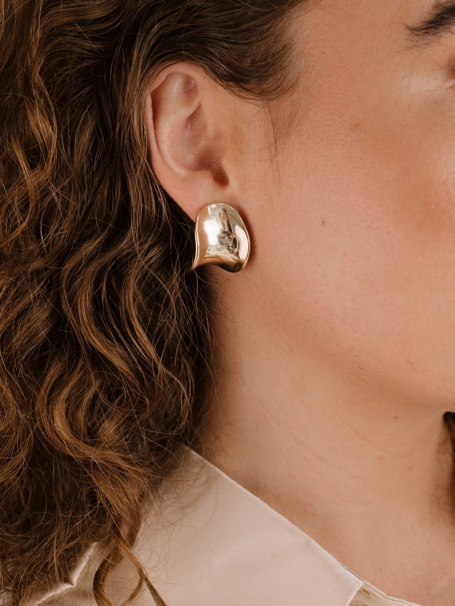 Curved Stud Earrings on model