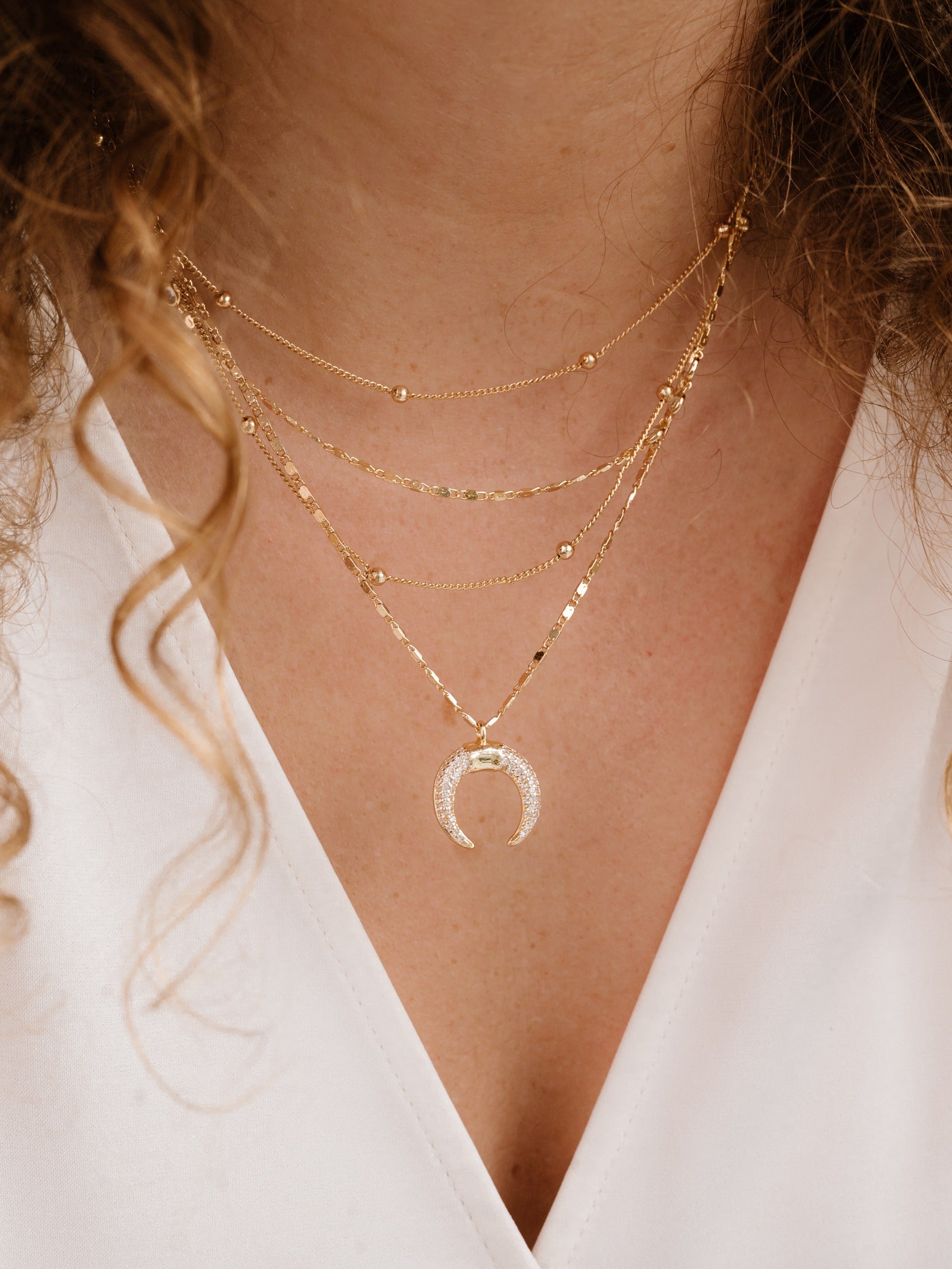 Layered Gold Chain & Crescent Horn Necklace on model