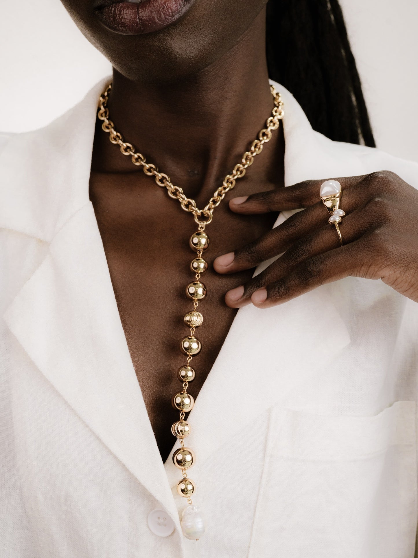 Deep Drop Pearl Lariat Necklace in gold on model 4