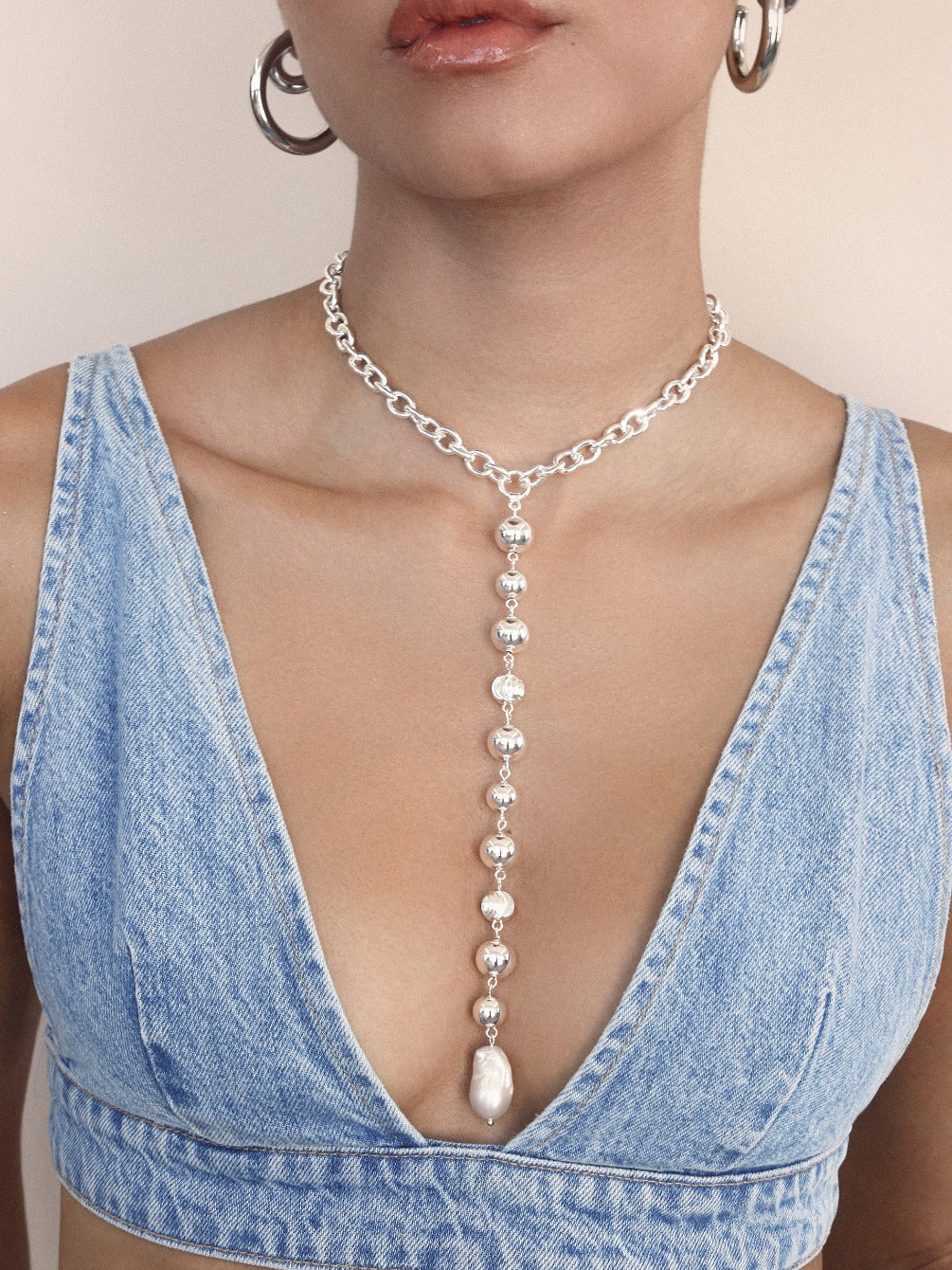 Deep Drop Pearl Lariat Necklace in silver on model