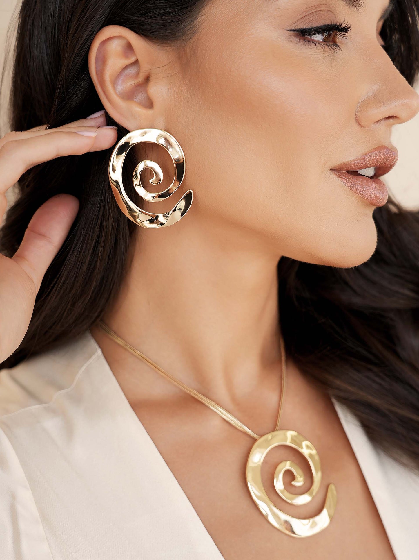 Aura Swirl Earrings on gold model