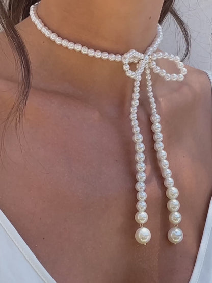 Venus Pearl Bow Necklace on model in video